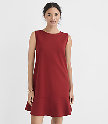 A woman in a red sleeveless dress stands against a plain white background. carousel Product Image 1