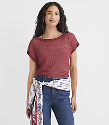 A woman in a maroon t-shirt and jeans stands against a plain white background, with a patterned scarf tied around her waist. carousel Product Image 1