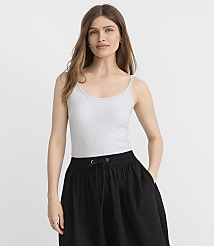 A woman in a grey ribbed tank top and a black skirt stands against a plain white background. carousel Product Image 2