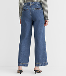 A person wearing wide-leg denim jeans and a striped shirt stands against a plain white background. carousel Product Image 3