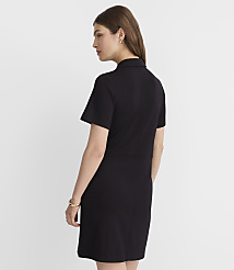 A woman in a black dress stands against a plain gray background. carousel Product Image 3
