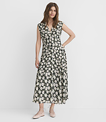 A woman in a floral dress stands against a plain white background. carousel Product Image 1