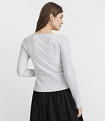 A woman in a grey ribbed long-sleeved shirt and a black skirt stands against a plain white background. carousel Product Image 3