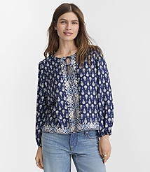 A woman in a blue patterned blouse and jeans stands against a plain white background. carousel Product Image 2