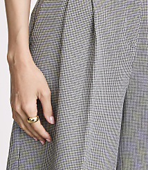 A hand with a gold ring rests on patterned fabric in the foreground, with more of the same fabric filling the background. carousel Product Image 4