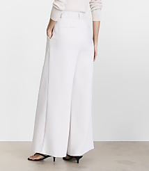 A person wearing white wide-leg pants and black heels stands against a plain, light-colored background. carousel Product Image 4