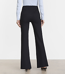 A person wearing black flared pants and a light blue sweater stands against a plain, light-colored background. carousel Product Image 3