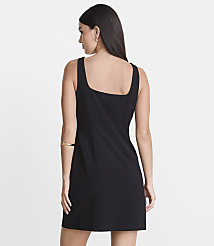 A woman in a black dress stands against a plain white background. carousel Product Image 3