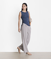 A woman in a blue top and striped pants stands against a plain white background. carousel Product Image 1
