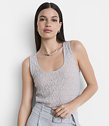A woman in a grey lace tank top and grey pants stands against a plain white background. carousel Product Image 2