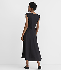 A woman in a black dress stands against a plain white background. carousel Product Image 3