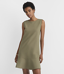 A woman in a green dress stands against a plain white background. carousel Product Image 1