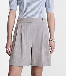 A person in the foreground wears light blue ribbed short sleeves and pinstripe shorts, against a plain white background. carousel Product Image 2