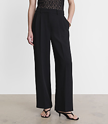 A person stands in black wide-leg trousers and sandals against a plain white background. carousel Product Image 2