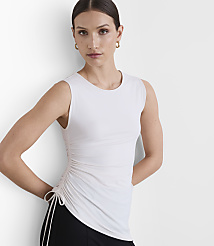 A woman in a white ruched tank top and black pants stands against a plain white background. carousel Product Image 2