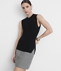 A woman in a black sleeveless top and a patterned skirt stands against a plain white background. carousel Product Image 2