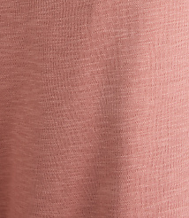 A close-up of a textured, dusty rose fabric fills the frame, with subtle variations in shade creating a soft, mottled background. carousel Product Image 4