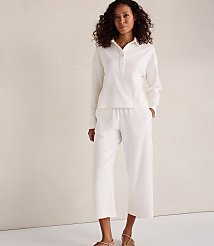 A woman in a white loungewear set stands against a plain, light-colored background. carousel Product Image 2