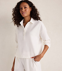 A woman in a white collared shirt and pants stands against a plain, light-colored background. carousel Product Image 1