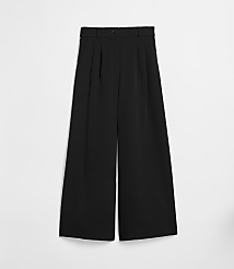 Black wide-leg trousers with pleats are laid flat against a plain white background. carousel Product Image 5