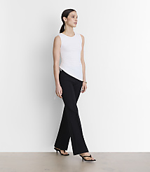 A woman in a white sleeveless top and black pants stands against a plain white background. carousel Product Image 1