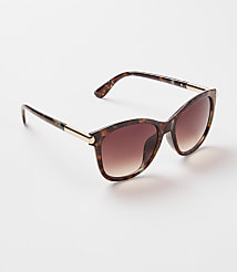 Tortoiseshell cat-eye sunglasses with gradient brown lenses rest on a plain white background. carousel Product Image 1
