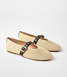 A pair of woven straw ballet flats with black straps and gold buckles rests on a plain white background. carousel Product Image 1
