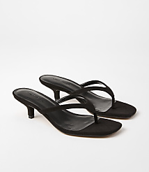 A pair of black suede thong sandals with kitten heels rests on a plain white background. carousel Product Image 1