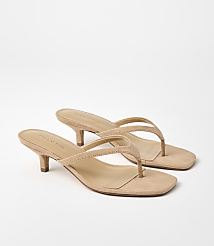 A pair of tan suede kitten heel thong sandals rests on a plain white background. carousel Product Image 1