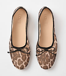 A pair of leopard-print mesh ballet flats with black bows are laid flat against a plain white background. carousel Product Image 3