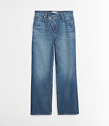 A pair of blue denim jeans with an asymmetrical waistband lies flat against a plain white background. carousel Product Image 5
