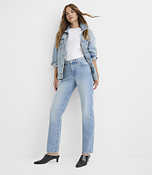 A woman in a denim jacket and jeans stands against a plain white background. carousel Product Image 1
