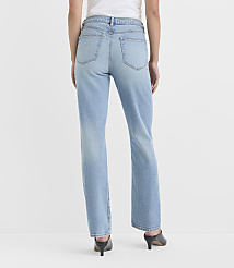 A person wearing light-wash denim jeans and black heels stands against a plain white background. carousel Product Image 2