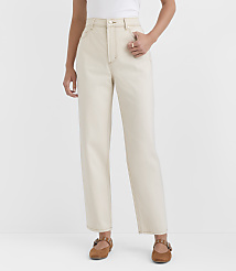 A person stands in the foreground wearing cream-colored jeans and brown flats against a plain white background. carousel Product Image 2