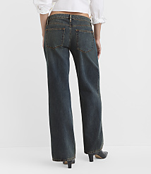 A person wearing dark wash, wide-leg jeans and black heels stands against a plain white background. carousel Product Image 2