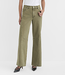 A person stands in the foreground wearing olive green wide-leg jeans and black heels against a plain white background. carousel Product Image 2