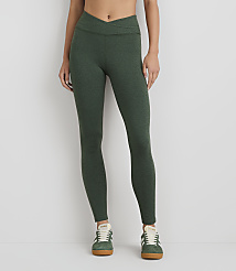 A person wearing green heathered leggings and green sneakers stands against a plain white background. carousel Product Image 3