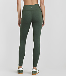 A woman wearing green heathered leggings and white-and-green sneakers stands against a plain white background. carousel Product Image 4