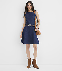 A woman in a denim dress, brown belt, and suede boots stands against a plain white background. carousel Product Image 1