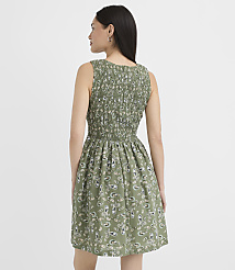 A woman in a green paisley print dress stands against a plain white background. carousel Product Image 3