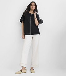 A woman in a black top and white pants stands against a plain white background. carousel Product Image 2
