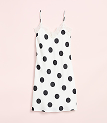 A white polka dot slip dress with lace trim hangs against a soft pink background. carousel Product Image 4