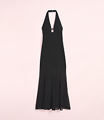 A black halterneck maxi dress with a flowing skirt is displayed against a soft pink background. carousel Product Image 2