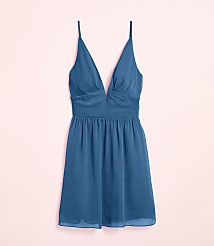 A teal slip dress with a deep V-neckline and spaghetti straps rests against a soft pink background. carousel Product Image 4