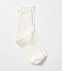 Two white ribbed socks lie on a plain white background. carousel Product Image 1