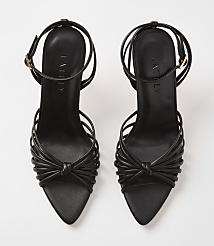 A pair of black strappy high-heeled sandals with knotted details in the foreground are set against a plain white background. carousel Product Image 3