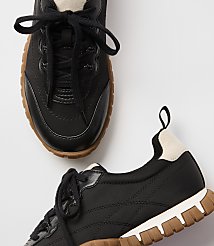 Black sneakers with tan soles are laid out on a white background. carousel Product Image 2