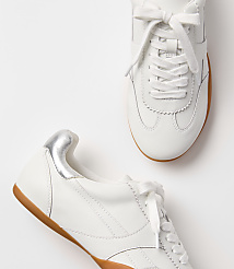Two white leather sneakers with gum soles and silver heel accents rest on a plain white background. carousel Product Image 2