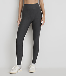 A person wearing dark grey ribbed leggings and white sneakers stands against a plain white background. carousel Product Image 2