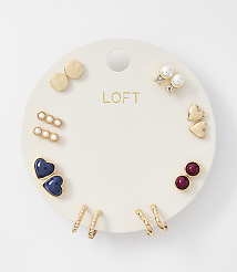 A white circular card displays a collection of gold and pearl earrings, including studs, hoops, and heart shapes, against a plain white background. carousel Product Image 1